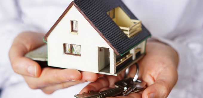 A closeup shot of a person thinking of buying or selling a house