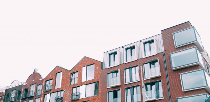 A low angle shot of a concrete brown building under the white sky